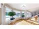 Bright sunroom with large windows and hardwood floors, perfect for relaxation and plants at 6260 Rain Dance Trl, Littleton, CO 80125