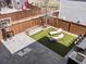 Charming backyard space featuring artificial turf, lounge chairs, and a basketball hoop for outdoor enjoyment at 5835 Chester Way, Denver, CO 80238