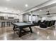 Finished basement with a pool table, bar area, and home theater setup perfect for entertaining guests at 5835 Chester Way, Denver, CO 80238