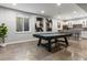 Spacious basement featuring a pool table, window, and wet bar with ample seating and modern finishes at 5835 Chester Way, Denver, CO 80238