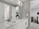 Bathroom with a double sink vanity, large mirror, and neutral walls at 5835 Chester Way, Denver, CO 80238