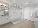 Open bathroom featuring double vanity, glass enclosed shower, and soaking tub at 5835 Chester Way, Denver, CO 80238