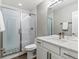 Modern bathroom featuring stylish tile shower, marble counter and sleek fixtures at 5835 Chester Way, Denver, CO 80238