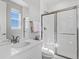 Well-lit bathroom with a glass-enclosed shower and vanity with sleek hardware at 5835 Chester Way, Denver, CO 80238