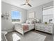 Charming bedroom with bright windows, a plush bed, and a stylish dresser at 5835 Chester Way, Denver, CO 80238