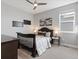 Comfortable bedroom with a dark wood bed frame, soft lighting, and ample natural light at 5835 Chester Way, Denver, CO 80238