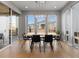 Bright dining room featuring modern lighting, light wood floors, and large windows providing ample natural light at 5835 Chester Way, Denver, CO 80238
