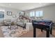Spacious game room with seating, a foosball table, and a basketball game at 5835 Chester Way, Denver, CO 80238