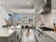 Bright kitchen with modern appliances, a farmhouse sink, and seamless transition to the dining area at 5835 Chester Way, Denver, CO 80238