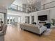Open-concept living room with soaring ceilings, fireplace, and a view of the dining area above at 5835 Chester Way, Denver, CO 80238