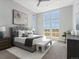 Serene main bedroom featuring a comfortable bed, modern decor, and large windows offering lots of natural light at 5835 Chester Way, Denver, CO 80238