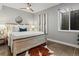 Inviting primary bedroom featuring a comfortable bed, stylish decor, and ample natural light from a bright window at 5835 Chester Way, Denver, CO 80238