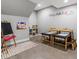 Bright and spacious play room with art supplies, tables, and an easel, ideal for creative activities at 5835 Chester Way, Denver, CO 80238
