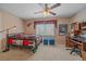 Comfortable bedroom featuring a ceiling fan and cozy decor with a large sunlit window at 15887 W Ellsworth Ln, Golden, CO 80401