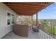 Covered deck with cushioned seating, outdoor lighting, and mountain views at 15887 W Ellsworth Ln, Golden, CO 80401
