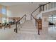 Spacious entryway with staircase, showcasing the home's elegant design and open layout at 15887 W Ellsworth Ln, Golden, CO 80401