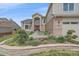 Inviting front yard with stone accents, lush landscaping, and a view of the home's exterior at 15887 W Ellsworth Ln, Golden, CO 80401