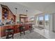 Gourmet kitchen with bar stool seating at the island, stainless appliances, and sliding door access at 15887 W Ellsworth Ln, Golden, CO 80401
