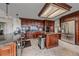 Spacious kitchen with stainless steel appliances, granite countertops, and custom dark wood cabinets at 15887 W Ellsworth Ln, Golden, CO 80401