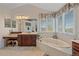Luxurious main bathroom featuring a soaking tub, vanity, and bright natural light at 15887 W Ellsworth Ln, Golden, CO 80401