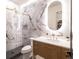 Modern bathroom with marble tile, glass shower, and gold fixtures, blending luxury and contemporary design at 40 Royal Ann Dr, Greenwood Village, CO 80111