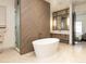 Elegant bathroom featuring a standalone tub, walk-in shower, and stylish finishes for a spa-like experience at 40 Royal Ann Dr, Greenwood Village, CO 80111