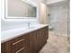 Elegant bathroom featuring illuminated mirror, modern vanity, and marble tiled walk-in shower at 40 Royal Ann Dr, Greenwood Village, CO 80111