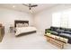 Spacious bedroom featuring seating area with leather couch and egress window offering natural light at 40 Royal Ann Dr, Greenwood Village, CO 80111