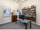 Well-lit home office with shelving, a glass desk, and ample natural light, ideal for productivity and comfort at 40 Royal Ann Dr, Greenwood Village, CO 80111
