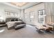 Bright and airy main bedroom featuring large windows and a seating area for relaxation and comfort at 40 Royal Ann Dr, Greenwood Village, CO 80111