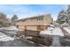 Attractive exterior of a townhome with snow-covered landscaping at 6967 E Girard Ave, Denver, CO 80224