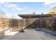 Enclosed backyard with wood fence, concrete patio, and garden beds are ready for entertaining at 12648 W Virginia Ave, Lakewood, CO 80228