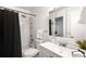 Neat bathroom featuring a shower/tub combo and vanity with a large mirror at 12648 W Virginia Ave, Lakewood, CO 80228