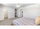 Bright bedroom with a ceiling fan, neutral carpeting, and an adjacent office space at 12648 W Virginia Ave, Lakewood, CO 80228