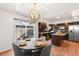 Eat-in kitchen with stainless steel appliances, pendant lighting, and backyard access at 12648 W Virginia Ave, Lakewood, CO 80228