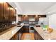 Modern kitchen featuring granite countertops, stainless steel appliances, and sleek cabinetry at 12648 W Virginia Ave, Lakewood, CO 80228