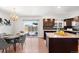 Eat-in kitchen with stainless steel appliances, pendant lighting, and backyard access at 12648 W Virginia Ave, Lakewood, CO 80228