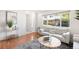Inviting living room with wood floors, neutral decor, and abundant natural light at 12648 W Virginia Ave, Lakewood, CO 80228
