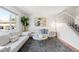 Bright living room with large window, modern decor, and plush gray carpet at 12648 W Virginia Ave, Lakewood, CO 80228