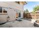 Back patio features a small cement pad, brick exterior, and a wood fence lining the backyard at 12648 W Virginia Ave, Lakewood, CO 80228