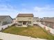 Large backyard featuring a well-maintained lawn, privacy fence, and a cozy patio area, perfect for outdoor enjoyment at 1527 Biffle Ct, Berthoud, CO 80513