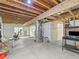 Unfinished basement area with exposed ceiling, mechanicals, concrete flooring, and a work out area at 1527 Biffle Ct, Berthoud, CO 80513