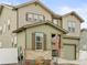 Two-story home with a stone facade, well-manicured lawn, attached garage, and covered porch at 1527 Biffle Ct, Berthoud, CO 80513