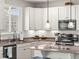 Modern kitchen with white cabinets, granite countertops, stainless steel appliances, and a sleek black faucet at 1527 Biffle Ct, Berthoud, CO 80513