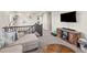 Upstairs living room showcasing comfortable seating, built in storage, natural lighting, and staircase at 1527 Biffle Ct, Berthoud, CO 80513