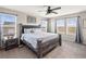 Spacious main bedroom with a large bed, bedside tables, and windows showcasing scenic views at 1527 Biffle Ct, Berthoud, CO 80513