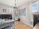 Home office with hardwood floors, large windows with coverings, and a spacious work area with desk at 1527 Biffle Ct, Berthoud, CO 80513