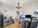 Bright home office featuring hardwood floors, a modern light fixture, and a spacious work area at 1527 Biffle Ct, Berthoud, CO 80513