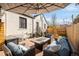 Spacious backyard with stone patio, wicker furniture, fire table, and string lights for entertaining at 945 Jackson St, Denver, CO 80206