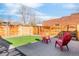 Stylish backyard with wooden deck, synthetic grass, and outdoor seating at 945 Jackson St, Denver, CO 80206